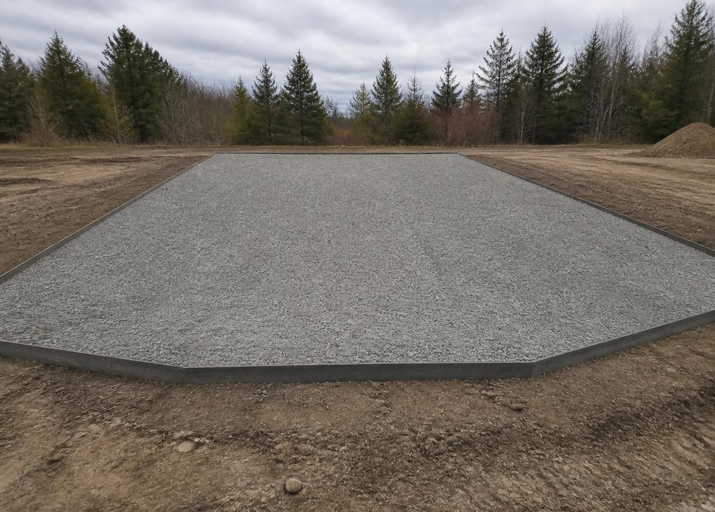 Finished compacted gravel building pad with straight, clean edges